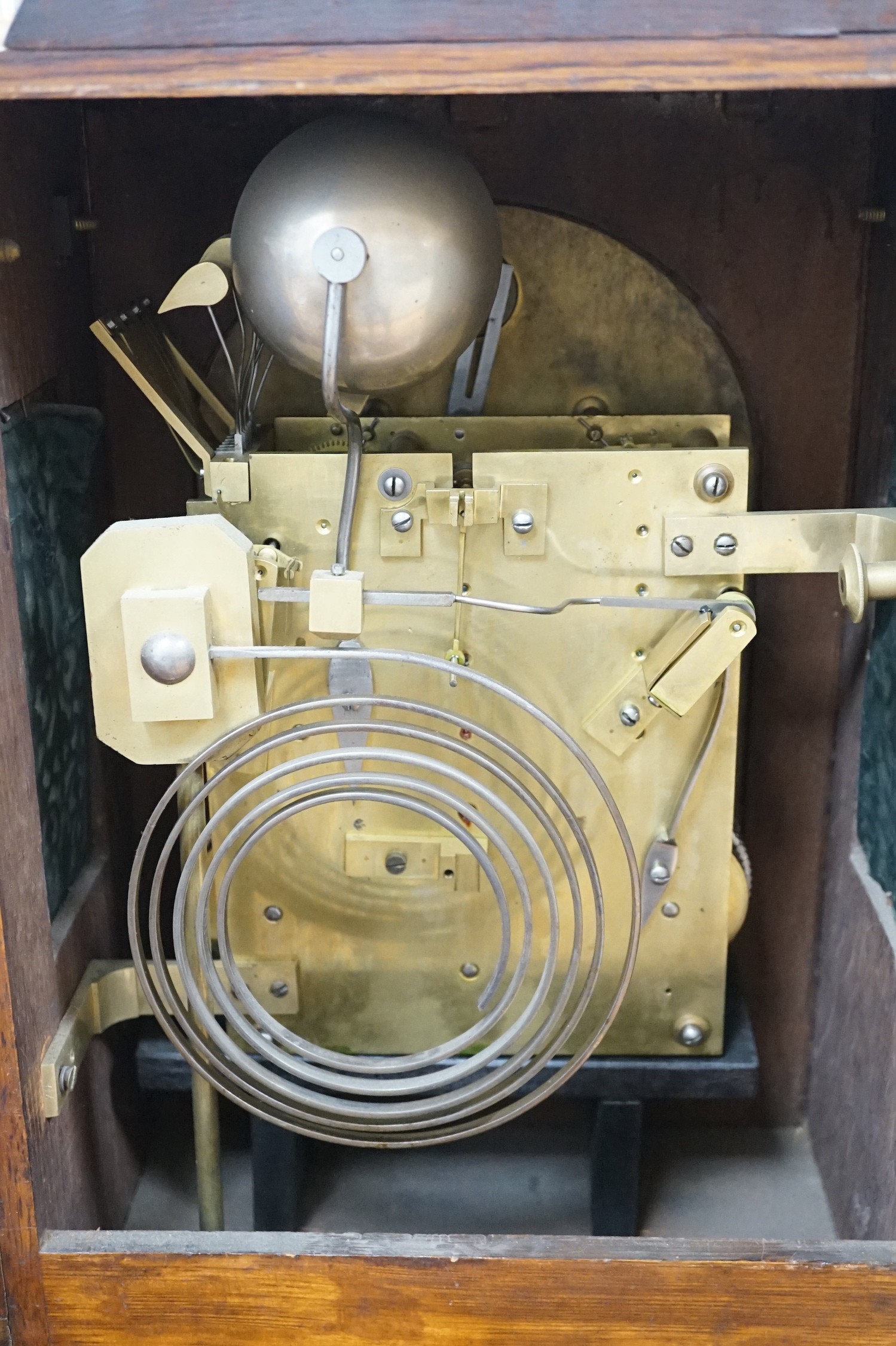 A late Victorian oak bracket clock with brass mounts and chiming movement, 55cms high
